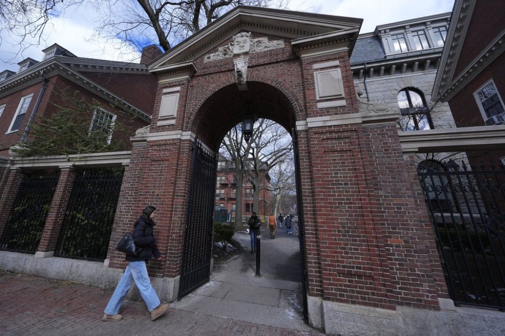 FILE - Pedestrians walk through the gates of Harvard Yard at Harvard University, Wednesday, Feb. 26, 2025, in Cambridge, Mass. (AP Photo/Charles Krupa, File)