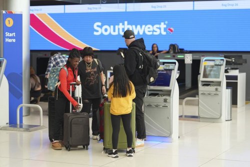 FILE - Passengers check in at a kiosk at the tocketing counter for Southwest Airlines in Denver International Airport Thursday, Feb. 27, 2025, in Denver. (AP Photo/David Zalubowski, File)