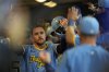 Milwaukee Brewers' Brice Turang is congratulated in the dugout after hitting a two-run home run during the fifth inning of a baseball game against the Cincinnati Reds, Friday, April 4, 2025, in Milwaukee. (AP Photo/Aaron Gash)
