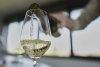 Winegrower Vincent Dampt serves a glass of Chablis wine in his office, in Chablis, Burgundy region, eastern France, Thursday, April 3, 2025. (AP Photo/Thibault Camus)