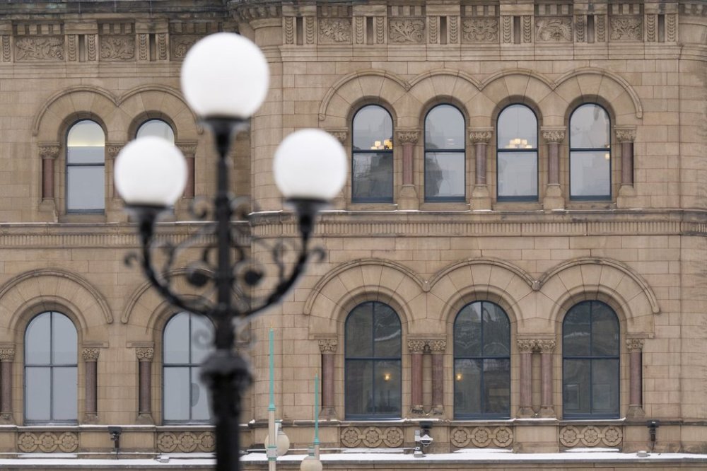 Lights illuminate the Office of the Prime Minister and Privy Council in the Parliamentary precinct on Monday, Feb. 3, 2025 in Ottawa. THE CANADIAN PRESS/Adrian Wyld