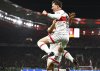 Stuttgart's Angelo Stiller, front, celebrates their side's first goal of the game with Stuttgart's Atakan Karazor during the German cup, DFB Pokal, semi-final soccer match between VfB Stuttgart and RB Leipzig in Stuttgart, Germany, Wednesday, April 2, 2025. (Tom Weller/dpa via AP)