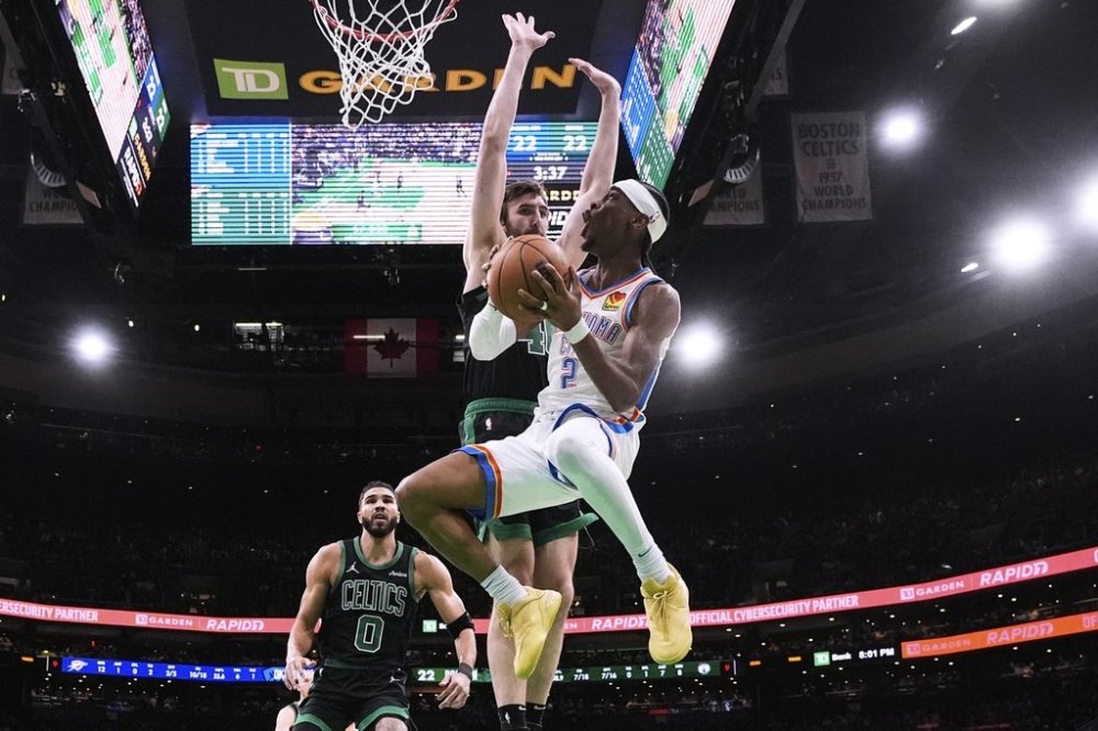 Oklahoma City Thunder guard Shai Gilgeous-Alexander (2) drive to the basket against Boston Celtics center Luke Kornet, rear right, and forward Jayson Tatum (0) during the first half of an NBA basketball game, Wednesday, March 12, 2025, in Boston. (AP Photo/Charles Krupa)