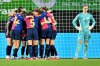 Barcelona's players celebrate their side's third goal during the Women's Champions League, quarter-final first leg, soccer match between VfL Wolfsburg and FC Barcelona in Wolfsburg, Germany, Wednesday, March 19, 2025. (Swen Pfoertner/dpa via AP)
