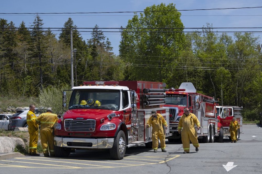 Firefighters arrive at a command centre within the evacuated zone while taking a break from battling the wildfire burning in Tantallon, N.S. outside of Halifax on May 31, 2023. THE CANADIAN PRESS/Darren Calabrese