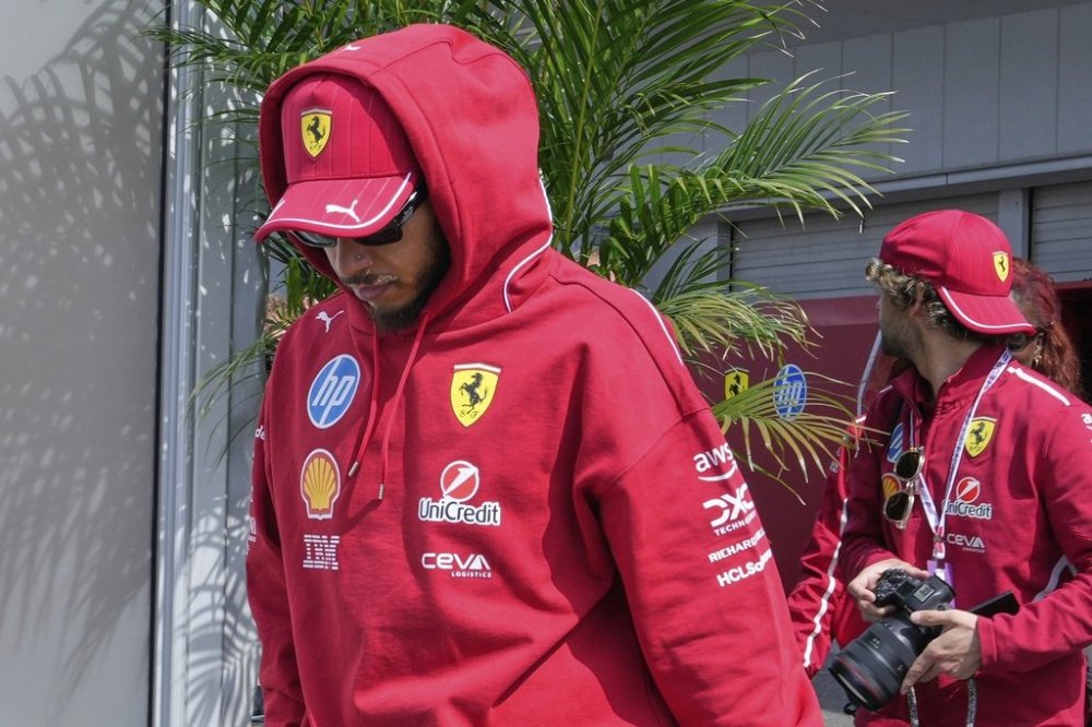 Ferrari driver Lewis Hamilton of Britain arrives his team house before the third practice session for the Japanese Formula One Grand Prix at the Suzuka Circuit in Suzuka, central Japan, Saturday, April 5, 2025. (AP Photo/Hiro Komae)