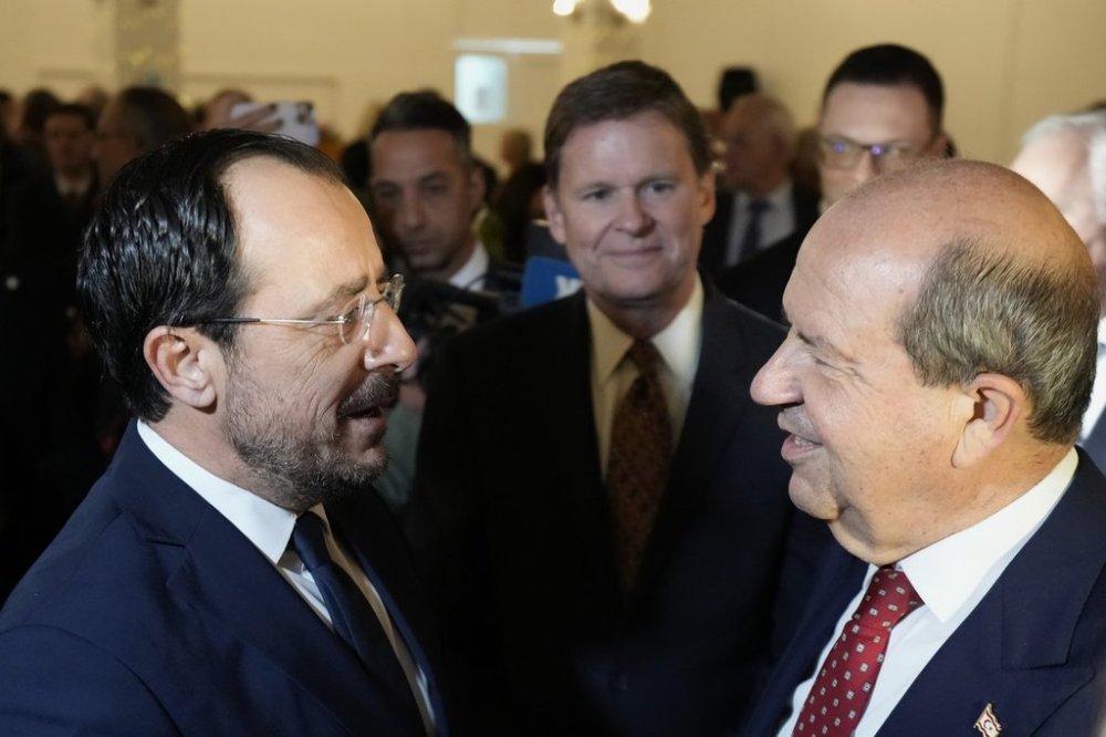 FILE - U.N. Secretary General's Special Representative in Cyprus Colin Stewart, center, Cyprus President Nikos Christodoulides, left, and the Turkish Cypriot leader Ersin Tatar talk as they attend the UN's end of year reception at Ledras Palace inside the U.N buffer zone in divided capital Nicosia, Cyprus, Tuesday, Dec. 10, 2024. (AP Photo/Petros Karadjias, File)