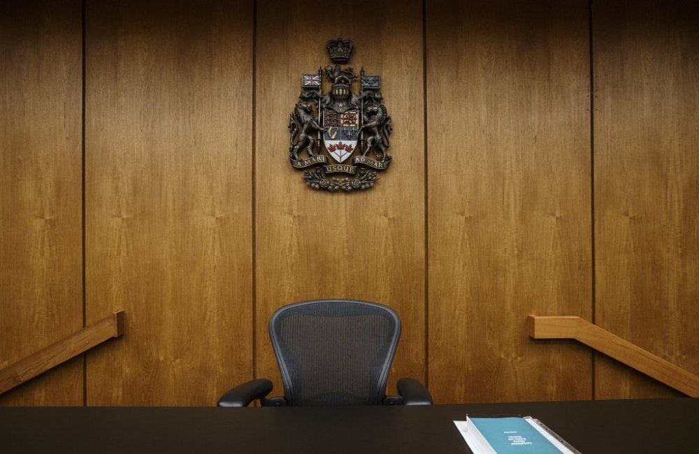 Judges bench at the Edmonton Law Courts building, in Edmonton on June 28, 2019. An Alberta judge has thrown out the case of a man accused of carrying counterfeit money because evidence showed the bills were very clearly Chinese knockoffs. THE CANADIAN PRESS/Jason Franson