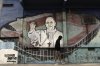 FILE - A man walks past a mural of Pope Francis at the stadium of San Lorenzo, his soccer team, in the Padre Ricciardelli neighborhood of Buenos Aires, Argentina, Feb. 25, 2025. (AP Photo/Rodrigo Abd, File)
