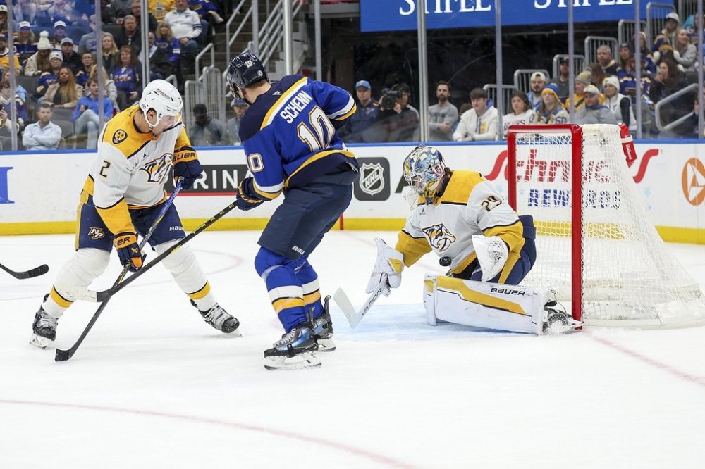 Nashville Predators goaltender Justus Annunen (29) stops the puck as Nashville Predators' Luke Schenn (2) and St. Louis Blues' Brayden Schenn (10) battle during the second period of an NHL hockey game Friday, Dec. 27, 2024, in St. Louis. (AP Photo/Scott Kane)