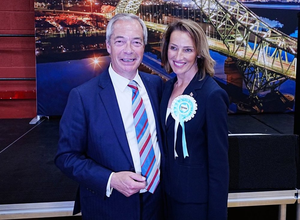 Reform UK's Sarah Pochin, right and party leader Nigel Farage talk to the media after the party won the seat in the Runcorn and Helsby by-election at DCBL Halton Stadium, Widnes, Cheshire, Friday, May 2, 2025. ( Peter Byrne/PA via AP)