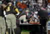San Diego Padres' Luis Arraez gives a thumbs up as he was carted off the field after a collision with Houston Astros second baseman Mauricio Dubon during the first inning of a baseball game Sunday, April 20, 2025, in Houston. (AP Photo/Karen Warren)