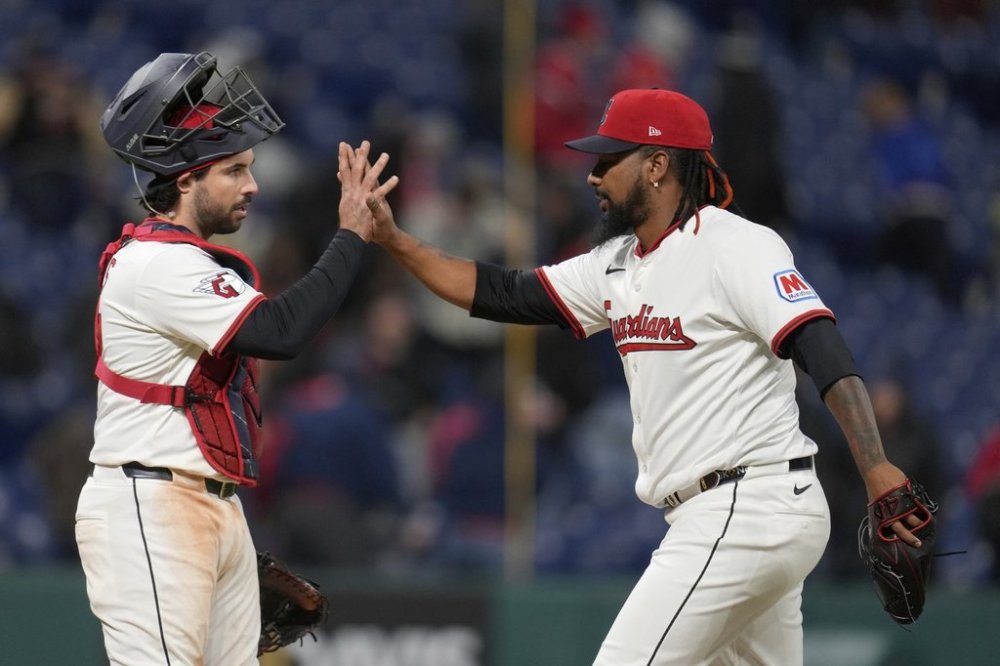 Cleveland Guardians catcher Austin Hedges, left, and relief pitcher Emmanuel Clase, right, celebrate after the Guardians defeated the Chicago White Sox in a baseball game in Cleveland, Wednesday, April 9, 2025. (AP Photo/Sue Ogrocki)