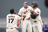San Francisco Giants catcher Patrick Bailey, center, is congratulated by Heliot Ramos (17), and Willy Adames after hitting a walk off single during the ninth inning of a baseball game against the Texas Rangers, Saturday, April 26, 2025, in San Francisco. (AP Photo/Benjamin Fanjoy)