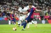 Real Madrid's Antonio Rudiger, left, challenges for the ball with Barcelona's Ferran Torres during the Spanish Copa del Rey final soccer match between Barcelona and Real Madrid at Estadio de La Cartuja stadium in Seville, Spain, Sunday, April 27, 2025. (AP Photo/Jose Breton)