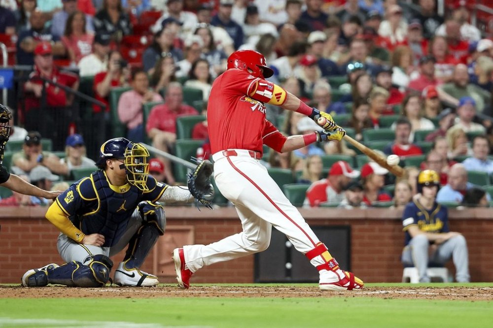 St. Louis Cardinals' Lars Nootbaar, right, hits an RBI single during the fifth inning of a baseball game against the Milwaukee Brewers, Friday, April 25, 2025, in St. Louis. (AP Photo/Scott Kane)