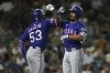 Texas Rangers' Marcus Semien, right, celebrates with teammate Adolis García (53) after hitting a three-run home run against the Athletics during the fifth inning of a baseball game Tuesday, April 22, 2025, in West Sacramento, Calif. (AP Photo/Scott Marshall)