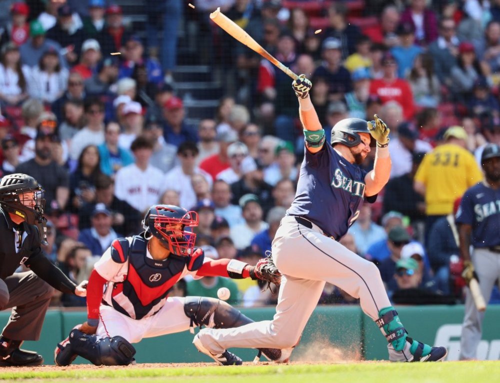 Seattle Mariners designated hitter Cal Raleigh (29) splinters the bat on a foul tip during the sixth inning of a baseball game against the Boston Red Sox, Thursday, April 24, 2025, in Boston. (AP Photo/Mark Stockwell)
