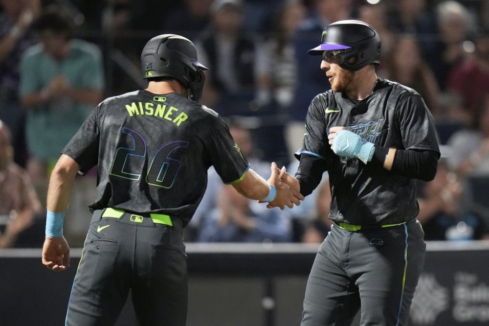 Tampa Bay Rays' Danny Jansen, right, celebrates his two-run home run off Atlanta Braves pitcher Bryce Elder with Kameron Misner (26) during the fourth inning of a baseball game Friday, April 11, 2025, in Tampa, Fla. (AP Photo/Chris O'Meara)