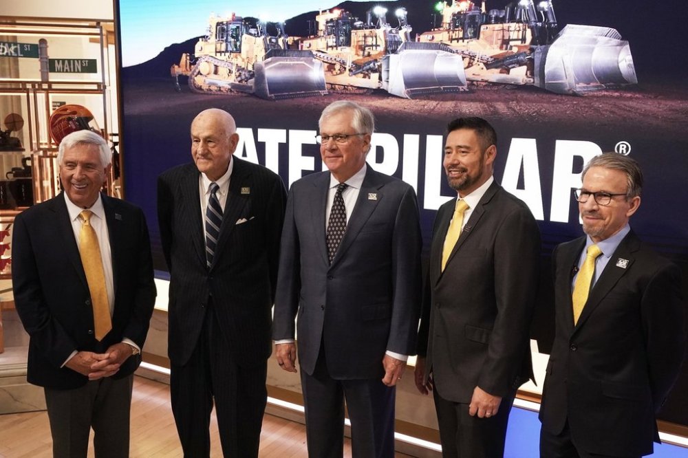 Current, former and incoming Caterpillar CEO's pose for photos on the floor of the New York Stock Exchange, Tuesday, April 15, 2025. From left are, Jim Owens; Donald Fites, Doug Oberhelman; incoming CEO Joe Creed, and current CEO Jim Umpleby. (AP Photo/Richard Drew)