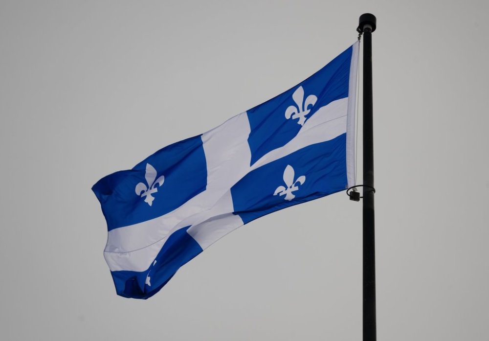 The Quebec Fleur-de-lis provincial flag flies on top of the National Assembly’s main tower, January 18, 2023 in Quebec City. THE CANADIAN PRESS/Jacques Boissinot