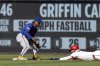 Washington Nationals' Luis García Jr., right, avoids a tag by New York Mets shortstop Francisco Lindor, left, and steals second base during the first inning of a baseball game in Washington, Monday, April 28, 2025. (AP Photo/Terrance Williams)