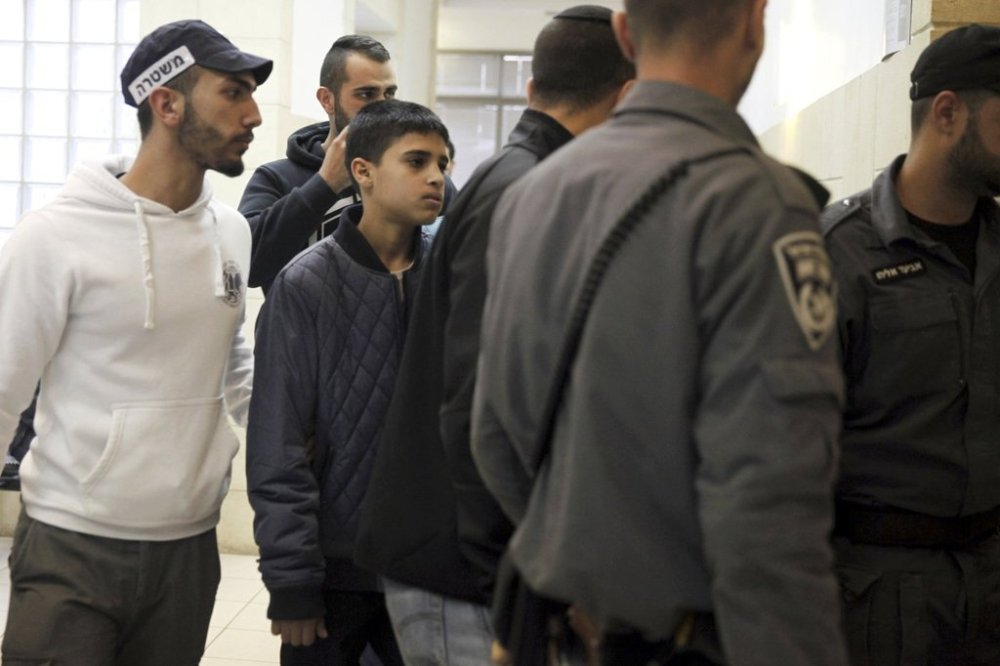 FILE - Ahmed Manasra, a 13-year-old Palestinian is brought to a court in Jerusalem, Tuesday Nov. 10, 2015. According to the indictment, Manasra and his cousin Hassan, 15, stabbed two Israelis in an east Jerusalem neighborhood. (AP Photo/Mahmoud Illean, File)