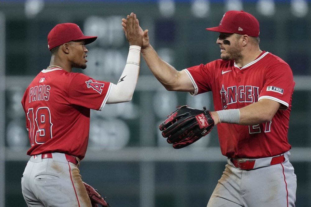 Los Angeles Angels second baseman Kyren Paris (19) and right fielder Mike Trout (27) celebrate after a baseball game against the Houston Astros, Saturday, April 12, 2025, in Houston. (AP Photo/Kevin M. Cox)