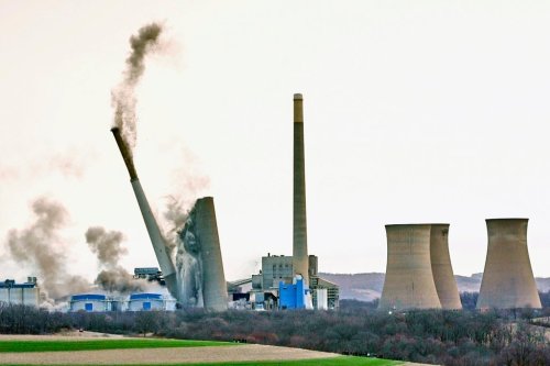 FILE - The smokestacks of the former coal-fired Homer City Generating Station crumble in a planned demolition to make way for a new natural gas-fired power plant in Homer City, Pa., March 22, 2025. (AP Photo/Gene J. Puskar, file)