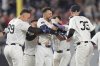 New York Yankees' J.C. Escarra, center, celebrates with teammates after hitting a walk-off sacrifice fly ball during the 10th inning of a baseball game against the San Diego Padres Wednesday, May 7, 2025, in New York. (AP Photo/Frank Franklin II)