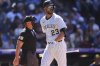 Colorado Rockies' Kris Bryant (23) heads to the dugout after striking out against Milwaukee Brewers relief pitcher Joel Payamps with the bases loaded in the eighth inning of a baseball game Thursday, April 10, 2025, in Denver. (AP Photo/David Zalubowski)