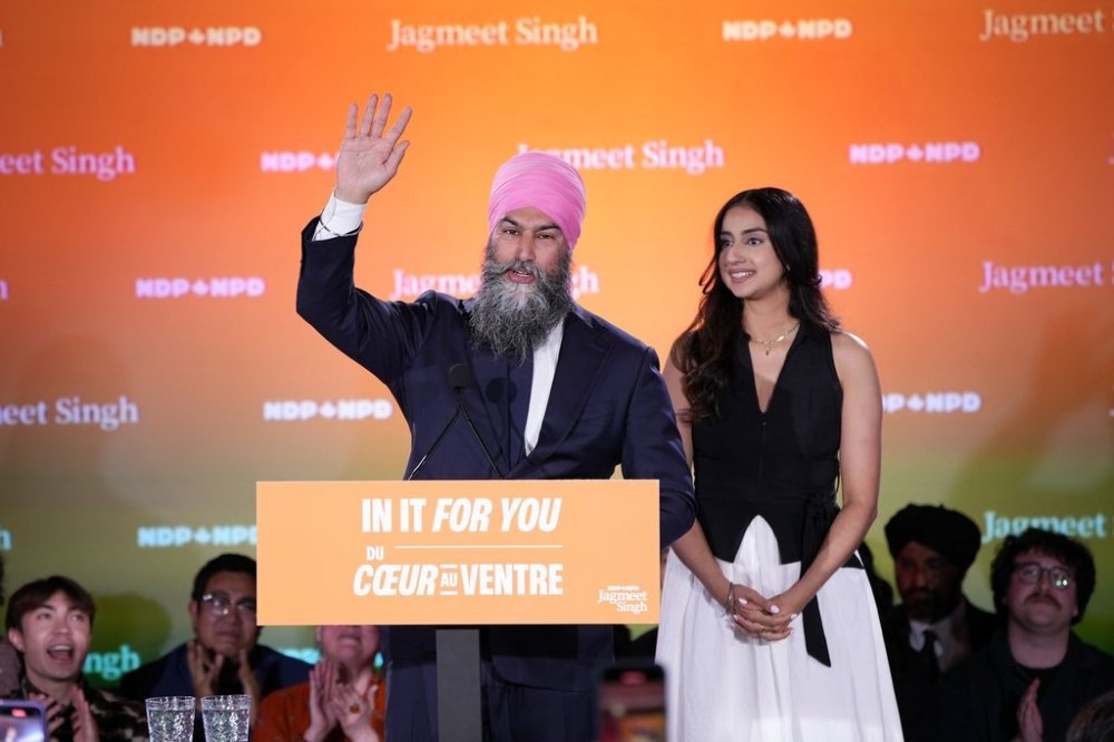 New Democratic Party Leader Jagmeet Singh addresses supporters accompanied by his wife Gurkiran Kaur at his campaign headquarters on election night in Burnaby, B.C., on April 28, 2025. THE CANADIAN PRESS/Ethan Cairns