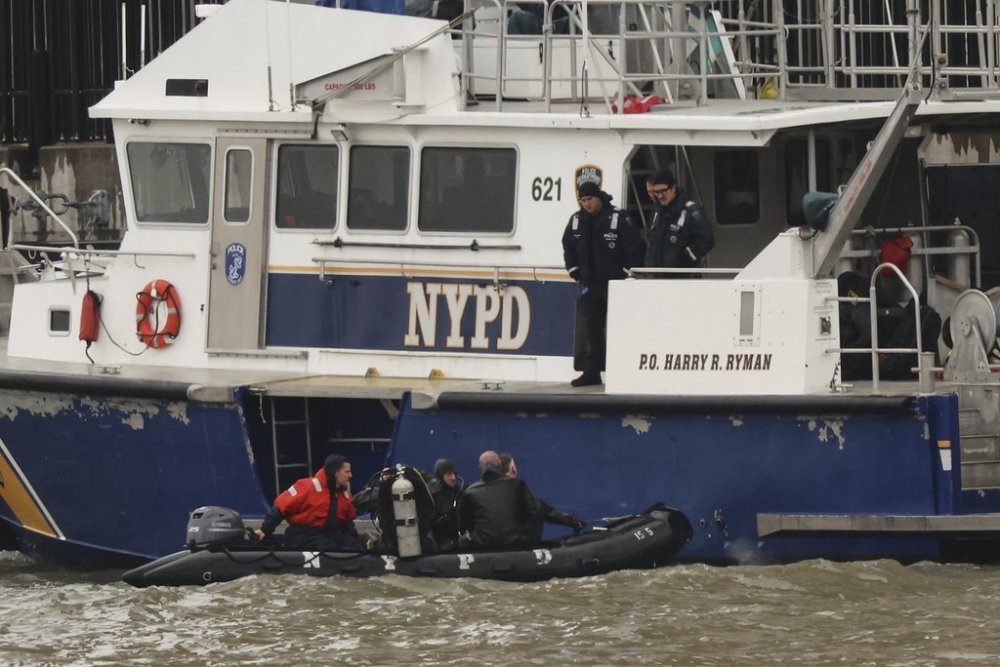 A New York Police Department scuba team prepares to dive, Friday, April 11, 2025, where a sightseeing helicopter crashed a day earlier into the Hudson River in Jersey City, N.J. (AP Photo/Yuki Iwamura)