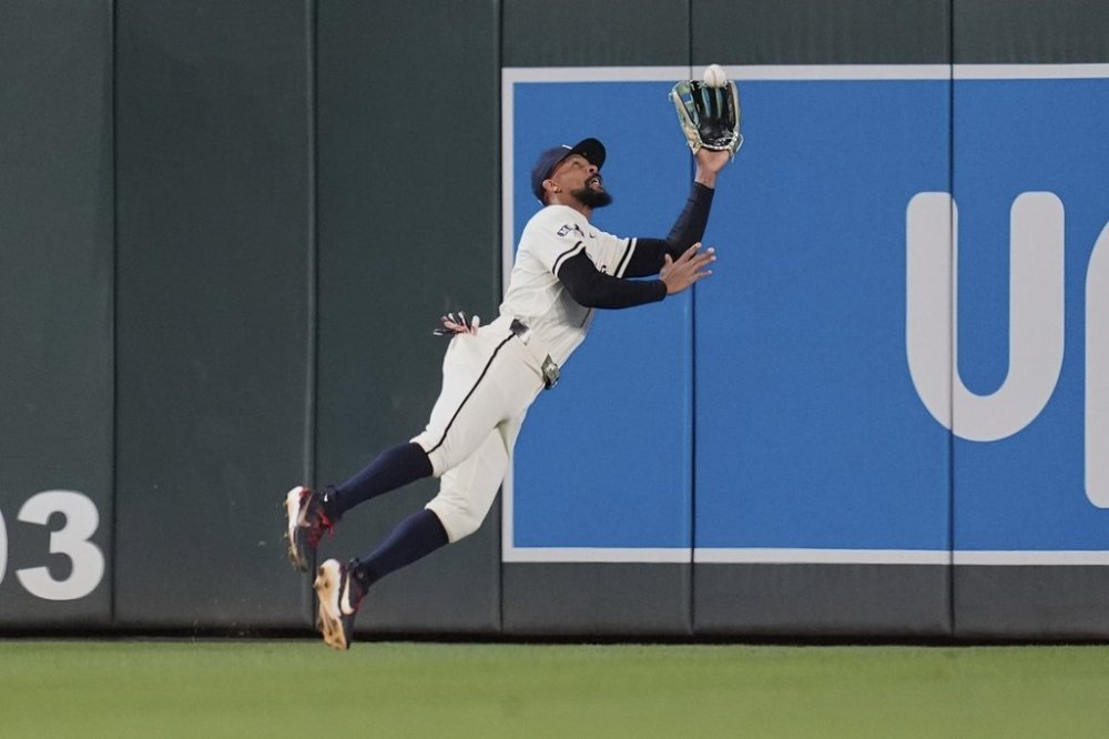 Minnesota Twins center fielder Byron Buxton (25) catches a fly out by Chicago White Sox's Andrew Benintendi (23) as the final out of a baseball game Tuesday, April 22, 2025, in Minneapolis. (AP Photo/Abbie Parr)