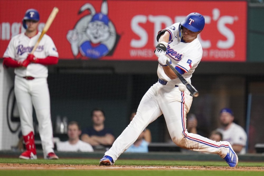 Texas Rangers' Corey Seager connects for a hit in the fifth inning of a baseball game against the Los Angeles Angels Wednesday, April 16, 2025, in Arlington, Texas. (AP Photo/Julio Cortez)