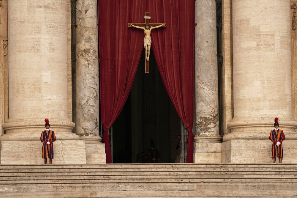 Pontifical Swiss guards stand outside the St. Peter's Basilica, in St. Peter's Square, where the body of Pope Francis will lie in state at for three days, at the Vatican, Wednesday, April 23, 2025. (AP Photo/Andreea Alexandru)