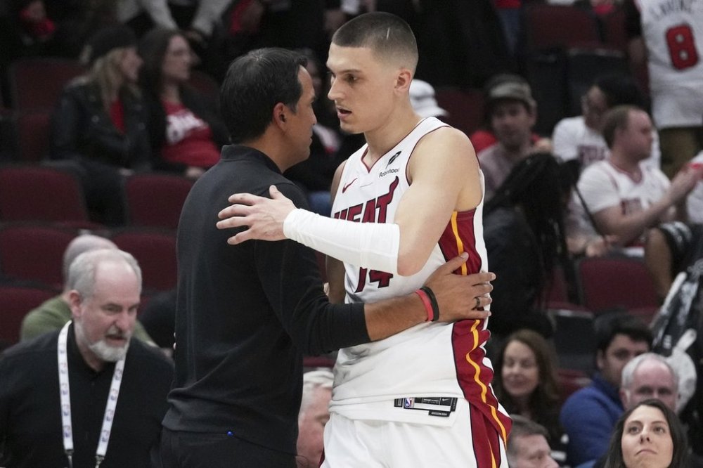 Miami Heat guard Tyler Herro, right, hugs head coach Erik Spoelstra during the second half of an NBA play-in tournament basketball game against the Chicago Bulls in Chicago, Wednesday, April 16, 2025. (AP Photo/Nam Y. Huh)