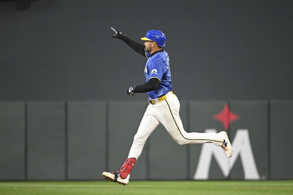 Minnesota Twins' Trevor Larnach celebrates as he rounds the bases after hitting a three-run home run off Los Angeles Angels pitcher Kyle Hendricks during the fourth inning of a baseball game, Friday, April 25, 2025, in Minneapolis. (AP Photo/Craig Lassig)