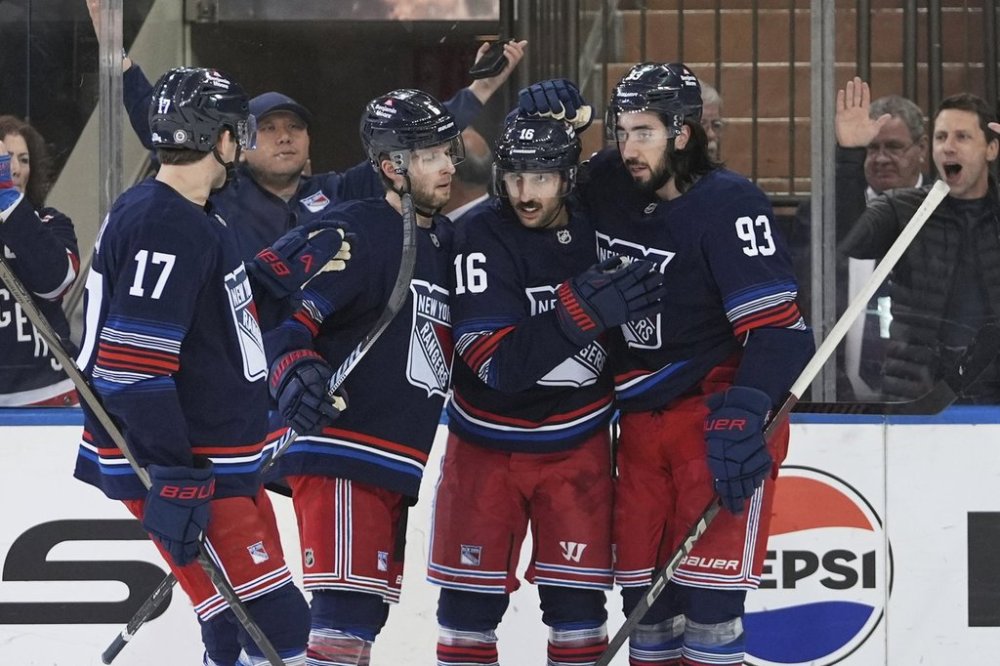 New York Rangers' Vincent Trocheck (16) celebrates with teammates Will Borgen (17), Mika Zibanejad (93) and Zac Jones (6) after scoring a goal during the first period of an NHL hockey game against the Philadelphia Flyers Wednesday, April 9, 2025, in New York. (AP Photo/Frank Franklin II)
