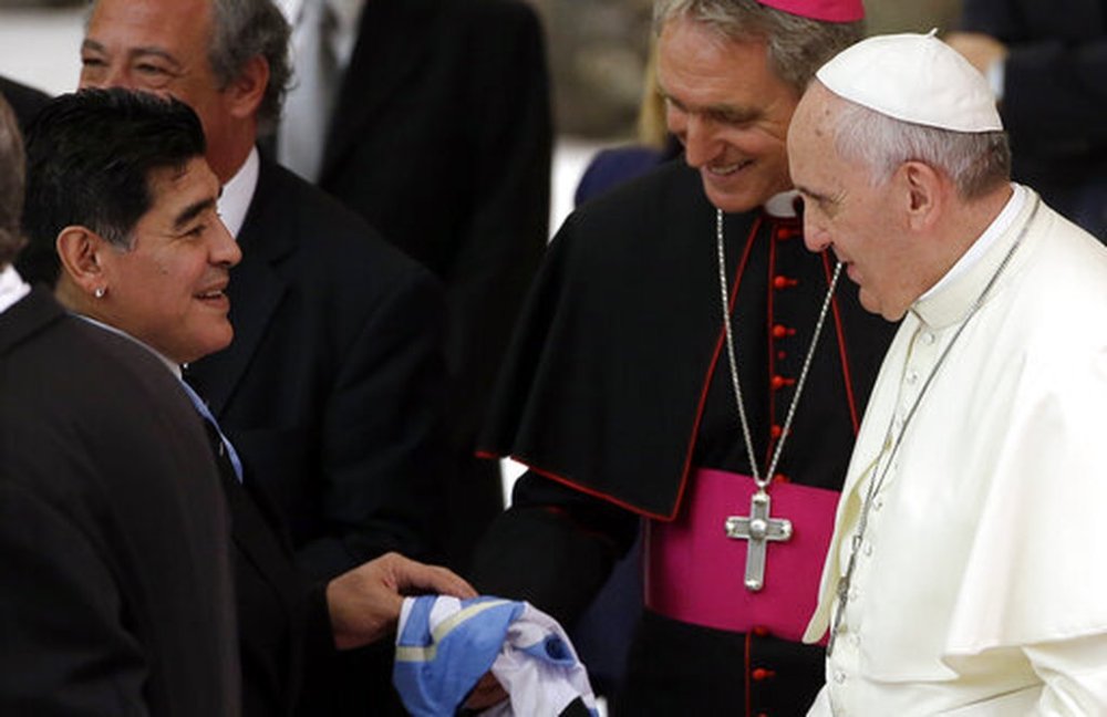 FILE - Argentine soccer legend Diego Armando Maradona, left, greets Pope Francis in the Paul VI hall at the Vatican, Monday, Sept. 1, 2014. (AP Photo/Gregorio Borgia, File)