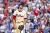 Philadelphia Phillies pitcher Jordan Romano watches a two run homer go over his head in the ninth inning of a baseball game against the Miami Marlins, Saturday, April 19, 2025, in Philadelphia. (AP Photo/Laurence Kesterson)