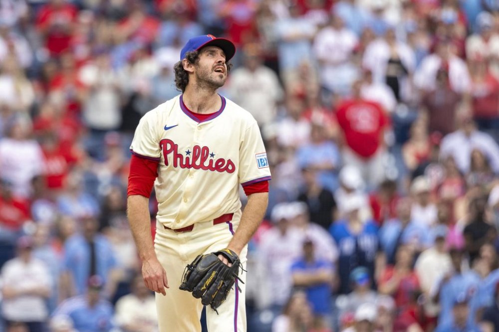 Philadelphia Phillies pitcher Jordan Romano watches a two run homer go over his head in the ninth inning of a baseball game against the Miami Marlins, Saturday, April 19, 2025, in Philadelphia. (AP Photo/Laurence Kesterson)