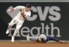 Seattle Mariners' Randy Arozarena slides into second base ahead of the throw to Boston Red Sox second baseman Romy Gonzalez during the seventh inning of a baseball game, Wednesday, April 23, 2025, in Boston. (AP Photo/Mark Stockwell)