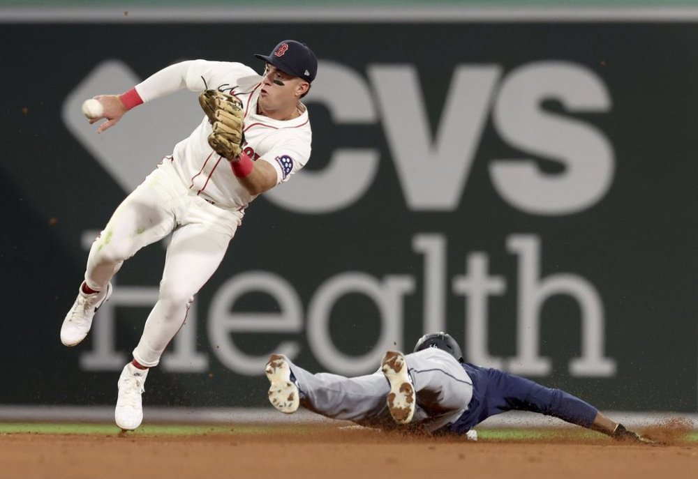 Seattle Mariners' Randy Arozarena slides into second base ahead of the throw to Boston Red Sox second baseman Romy Gonzalez during the seventh inning of a baseball game, Wednesday, April 23, 2025, in Boston. (AP Photo/Mark Stockwell)