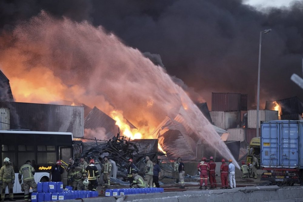 Firefighters try to extinguish the fire, Sunday, April 27, 2025, after a massive explosion and fire rocked a port near the southern port city of Bandar Abbas, Iran, on Saturday. (Mahdi Nori/Fars News Agency via AP)