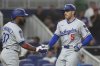 Los Angeles Dodgers' Freddie Freeman (5) celebrates a two-run home run with Teoscar Hernández (37) during the third inning of a baseball game against the Miami Marlins, Monday, May 5, 2025, in Miami. (AP Photo/Marta Lavandier)