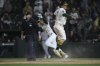 Athletics Luis Urías, right, slides into home safely to score the game winning run against the Texas Rangers during the ninth inning of a baseball game Thursday, April 24, 2025, in West Sacramento, Calif. (AP Photo/Scott Marshall)