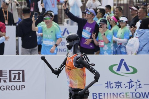 The Sky Project Ultra robot also known as Tien Kung Ultra crosses the finish line to win the Humanoid Robot Half-Marathon held in Beijing on Saturday, April 19, 2025. (AP Photo/Ng Han Guan)