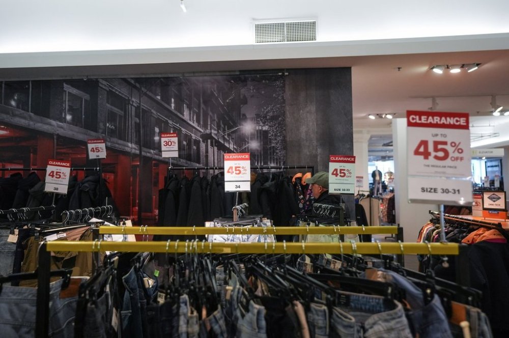Clearance signs are displayed on racks of clothing at the flagship downtown Hudson's Bay store, in Vancouver, on Monday, March 24, 2025. THE CANADIAN PRESS/Darryl Dyck