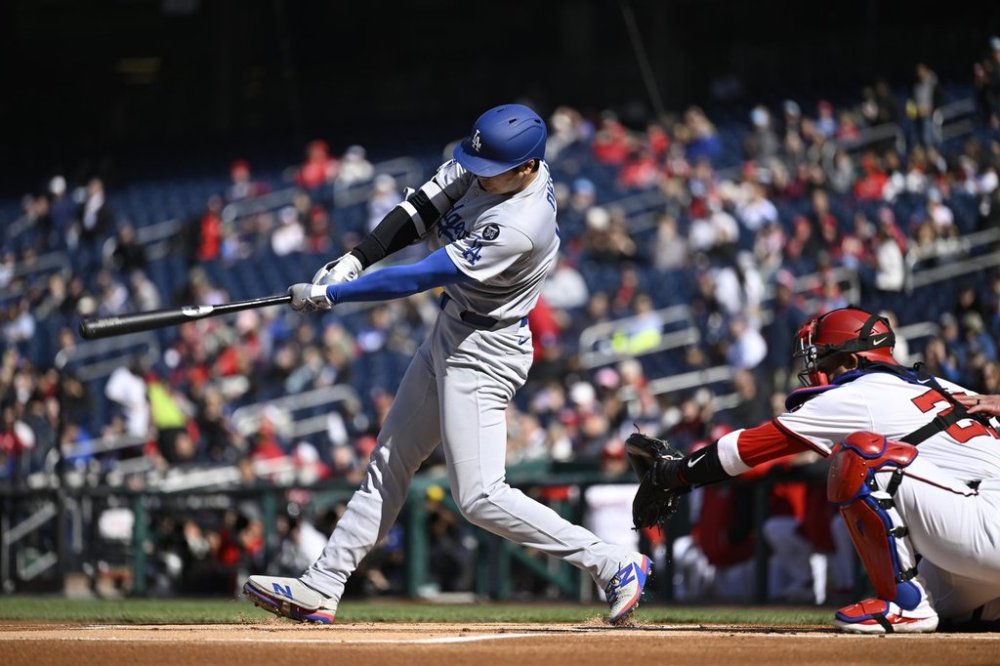 Los Angeles Dodgers Shohei Ohtani hits a single during the first inning of a baseball game against the Washington Nationals, Wednesday, April 9, 2025, in Washington. (AP Photo/John McDonnell)